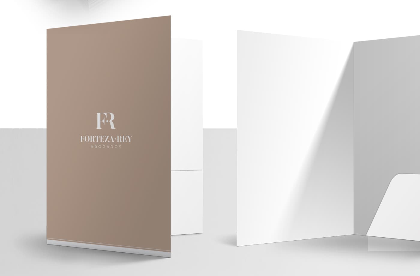 Taupe-brown corporate folder with the FR monogram of Forteza-Rey Abogados