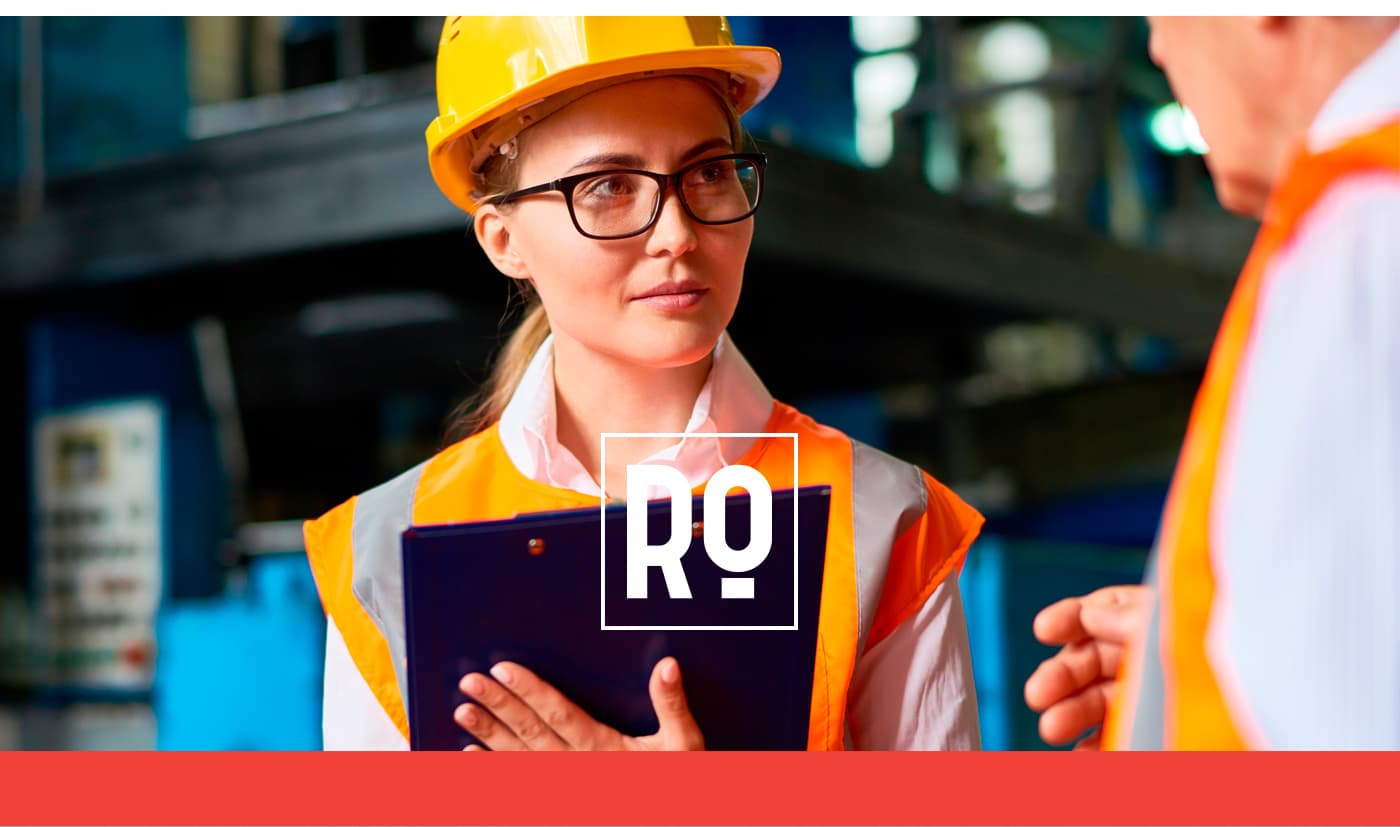 RC symbol in white overlaid on a photograph of a worker with a helmet and reflective vest