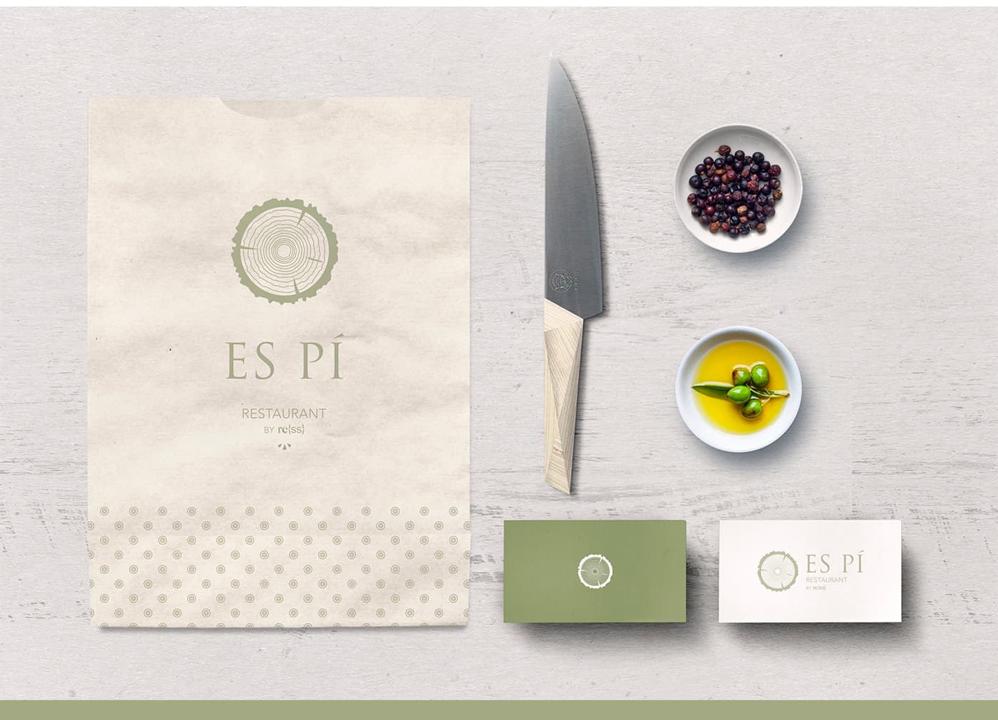 Es Pí paper bag, knife and business cards next to olives and nuts