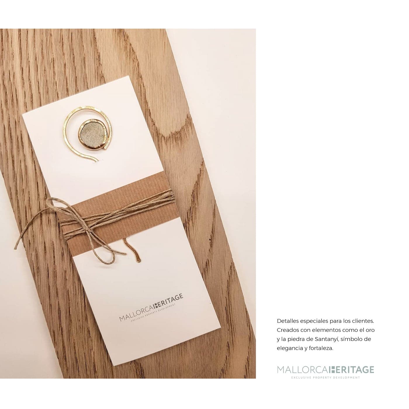 Detail of a card with a gold ring and stone, tied with thread on a wooden board