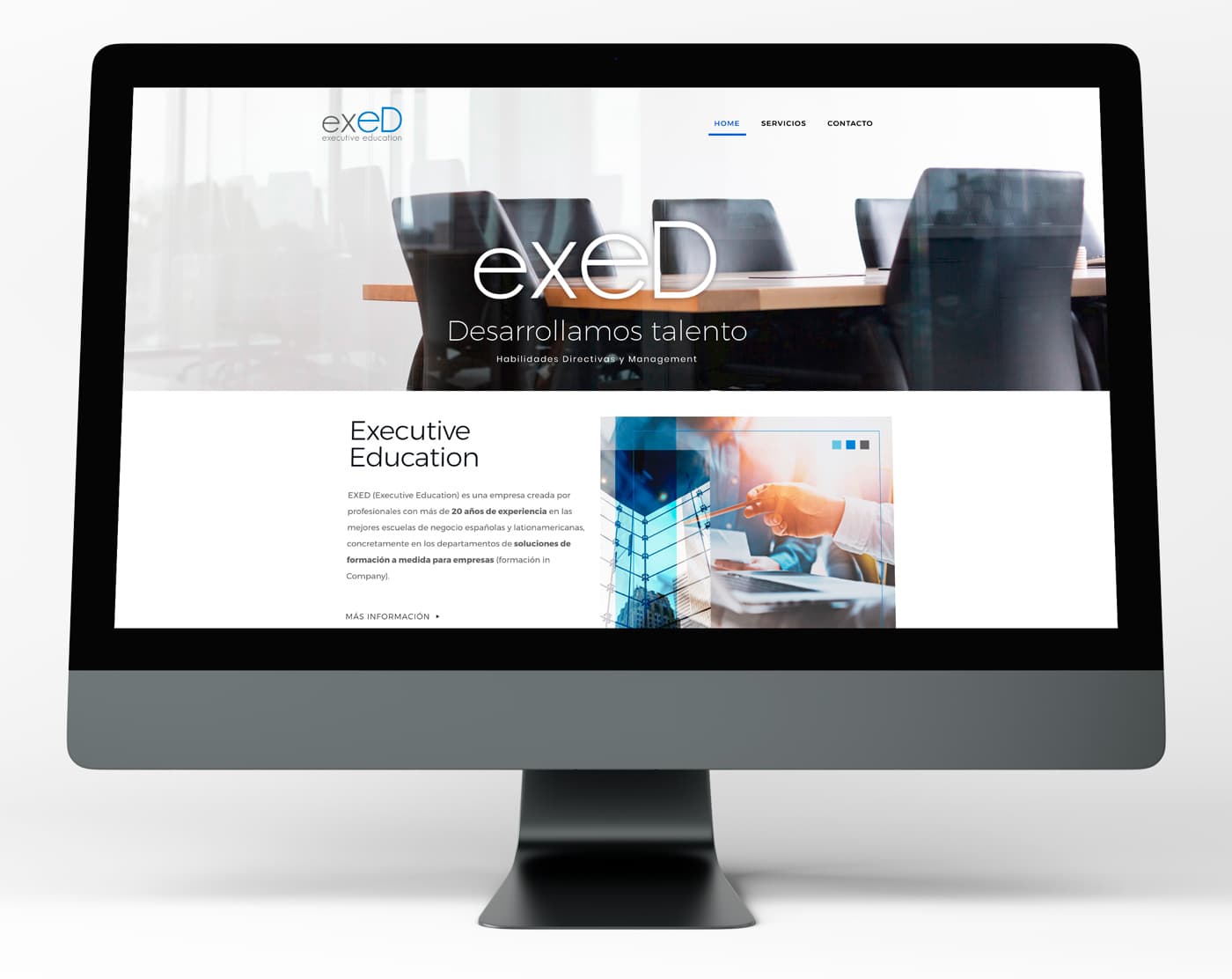EXED website on an iMac showing the home page with a meeting room and the Executive Education section