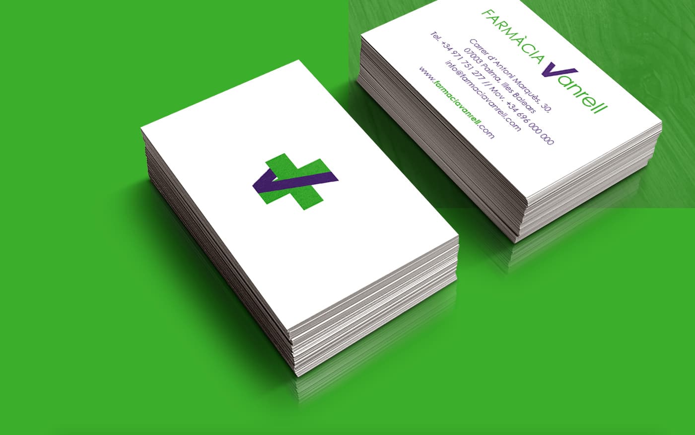 Green business cards with the pharmacy's symbol and contact details