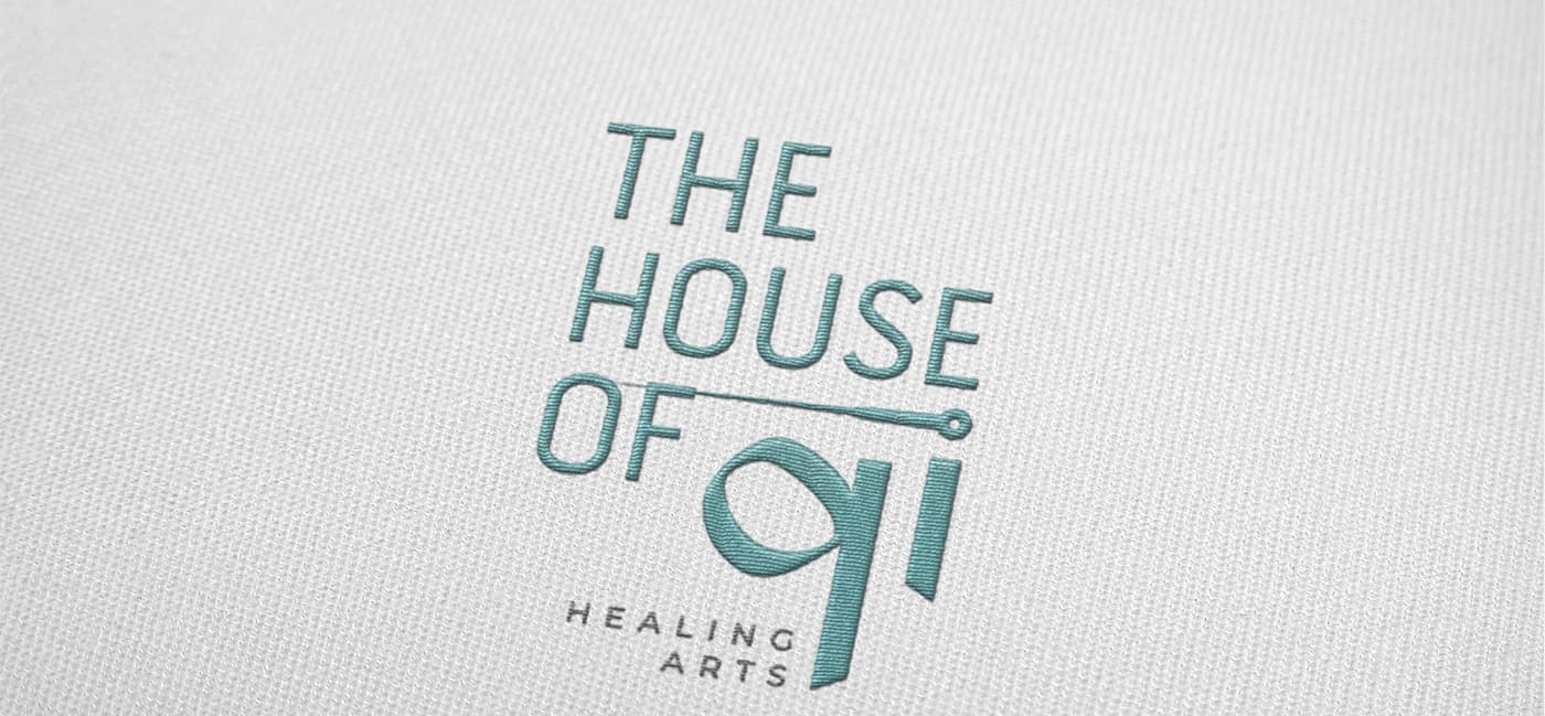 Logotype embroidered in turquoise thread on a textile garment