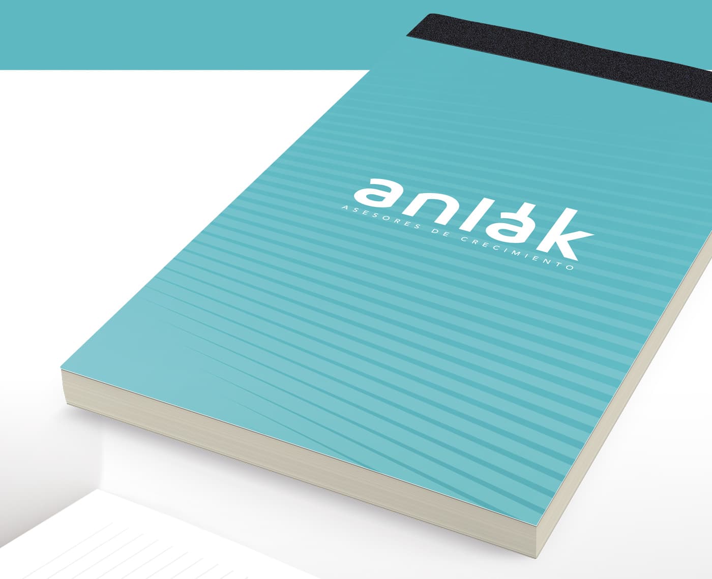 Mockup de llibreta corporativa amb el logotip d'Anlak en turquesa