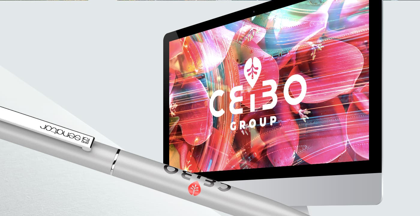 Mockup del logotipo de Ceibo Group en pantalla de ordenador junto a bolígrafo corporativo