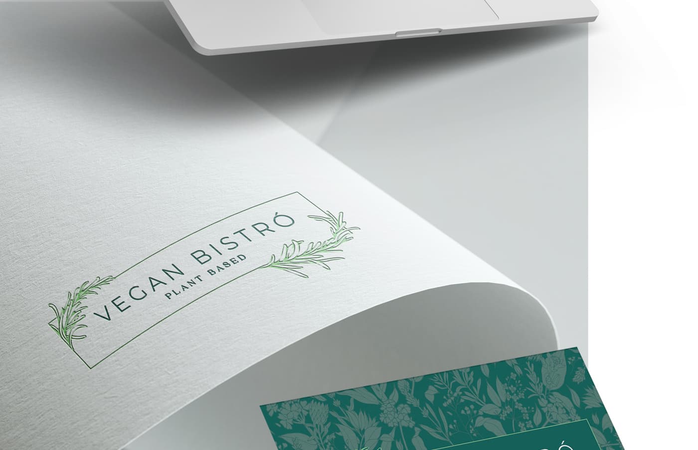 Mockup of the logotype embossed in relief on a curved sheet of paper