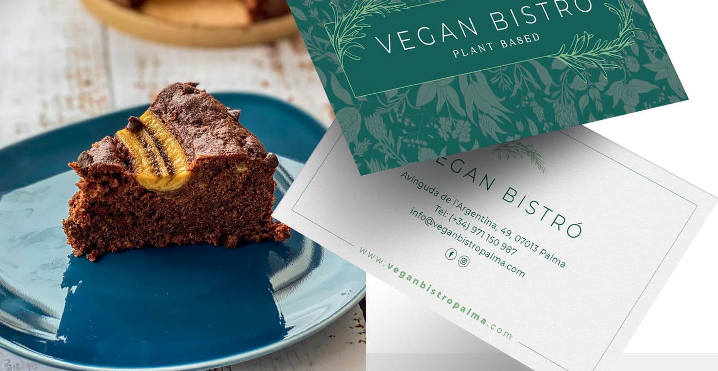Business cards with a green floral print next to a slice of banana bread