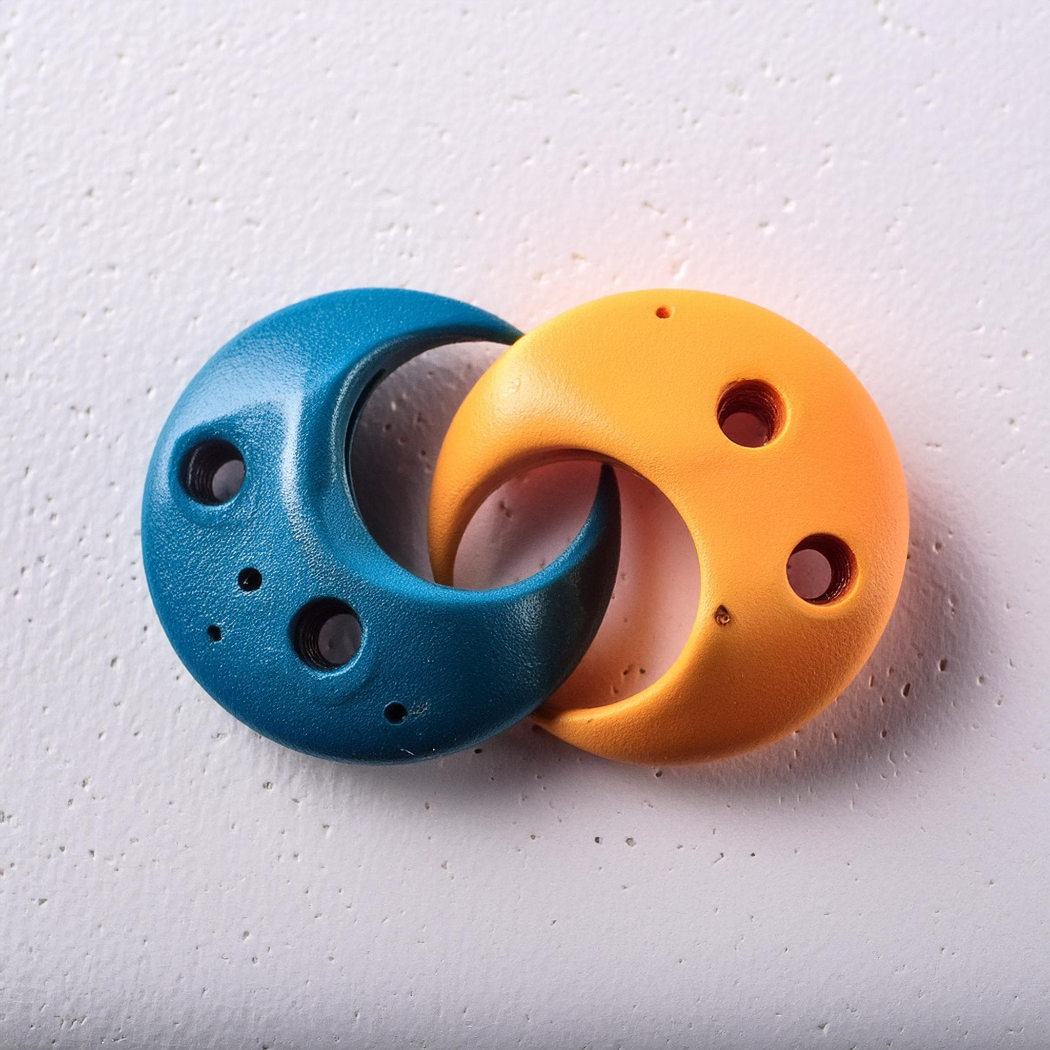 Blue and orange climbing holds intertwined as the logo's symbol
