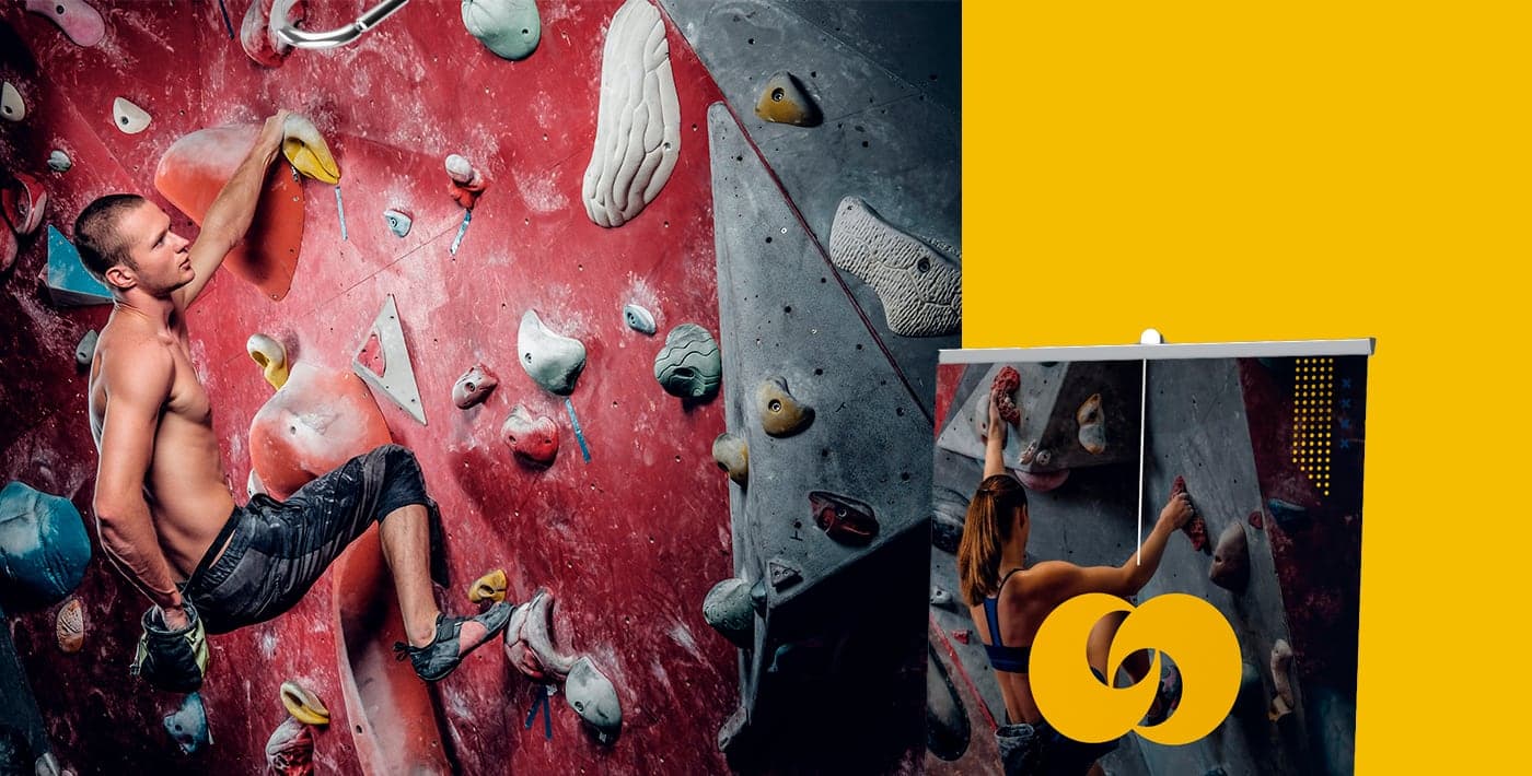 Climber at the climbing wall next to the brand's advertising roll-up
