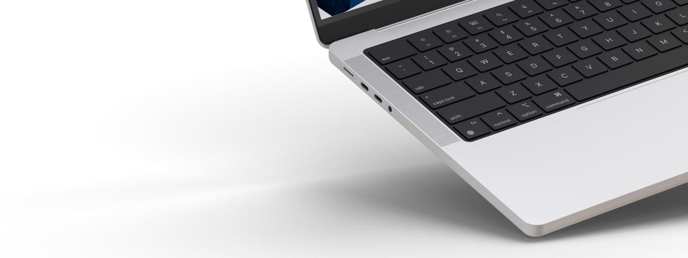 Detail of the laptop's side and keyboard with the website in the background