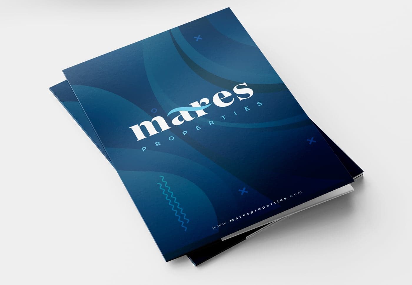Cover of a navy blue corporate folder with waves and the Mares Properties logo