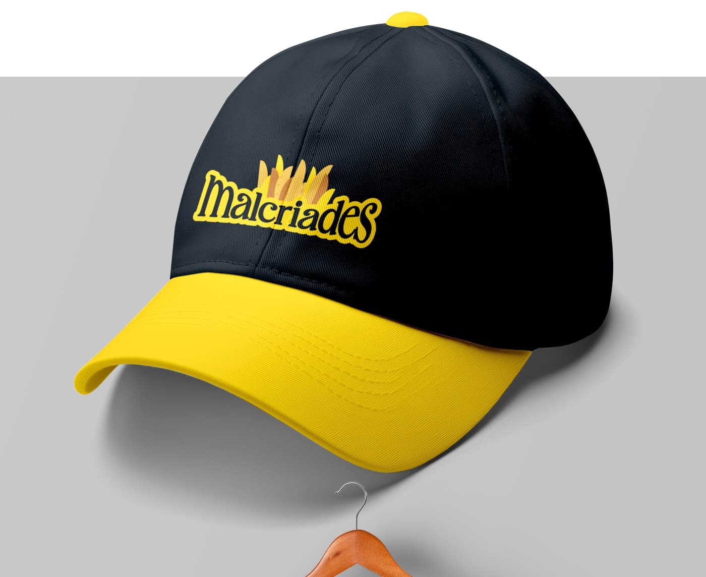 Black and yellow cap embroidered with the full Malcriades logo