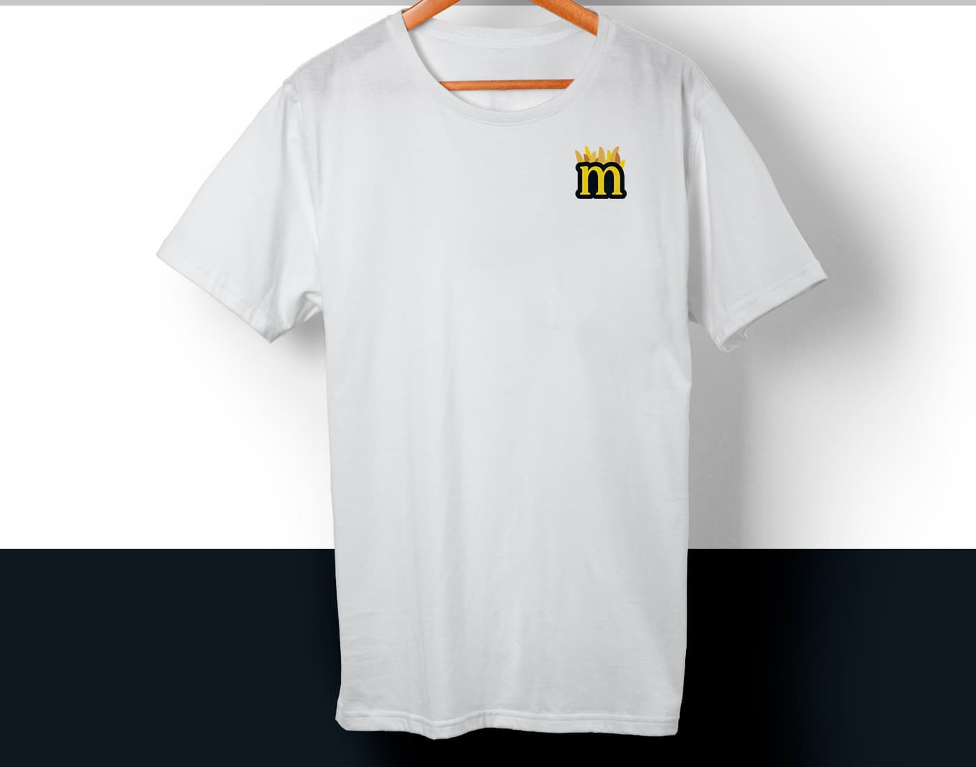 White T-shirt with the crowned m icon, topped with potato wedges, embroidered on the chest