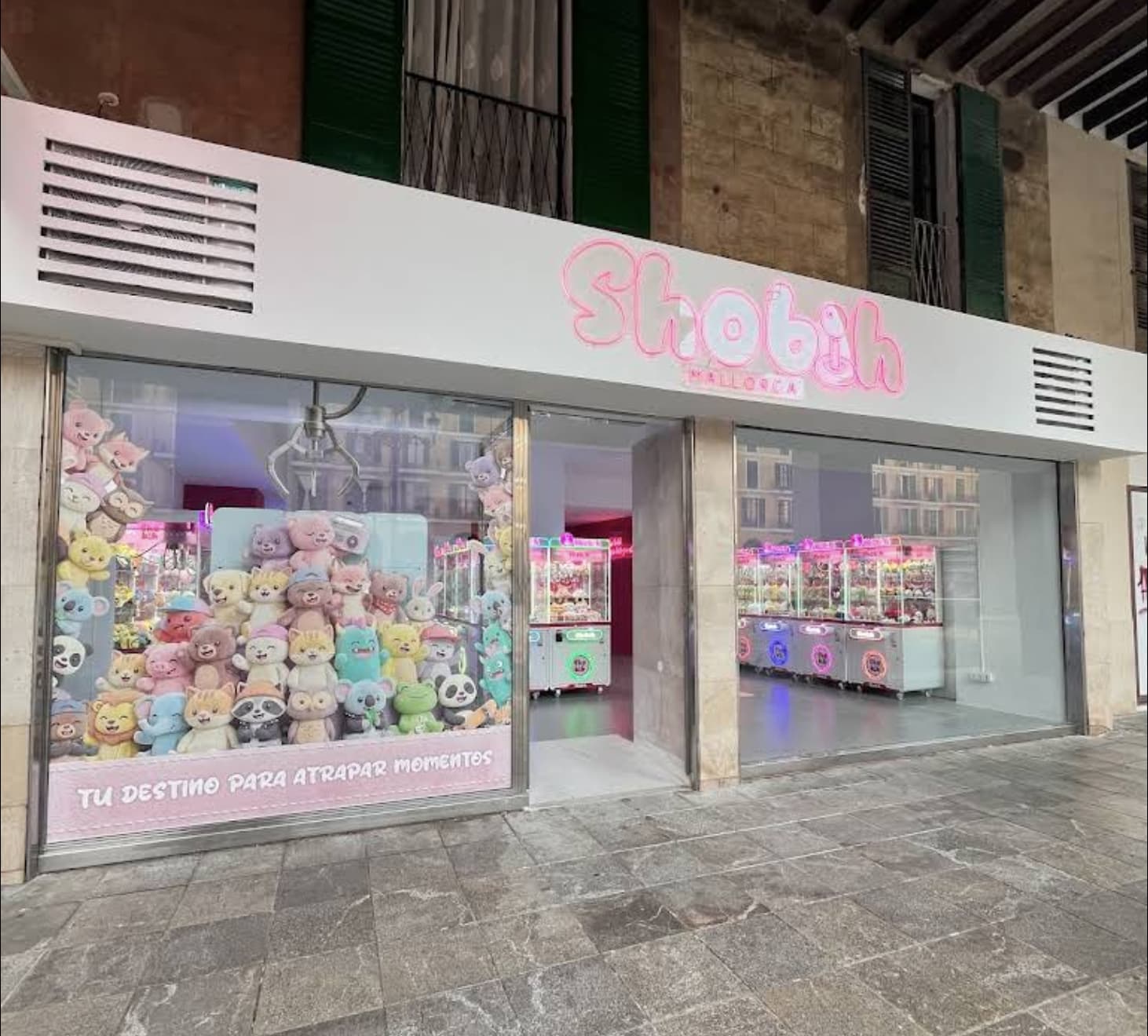 Daytime shop window with plush toys and the tagline Your destination to catch moments