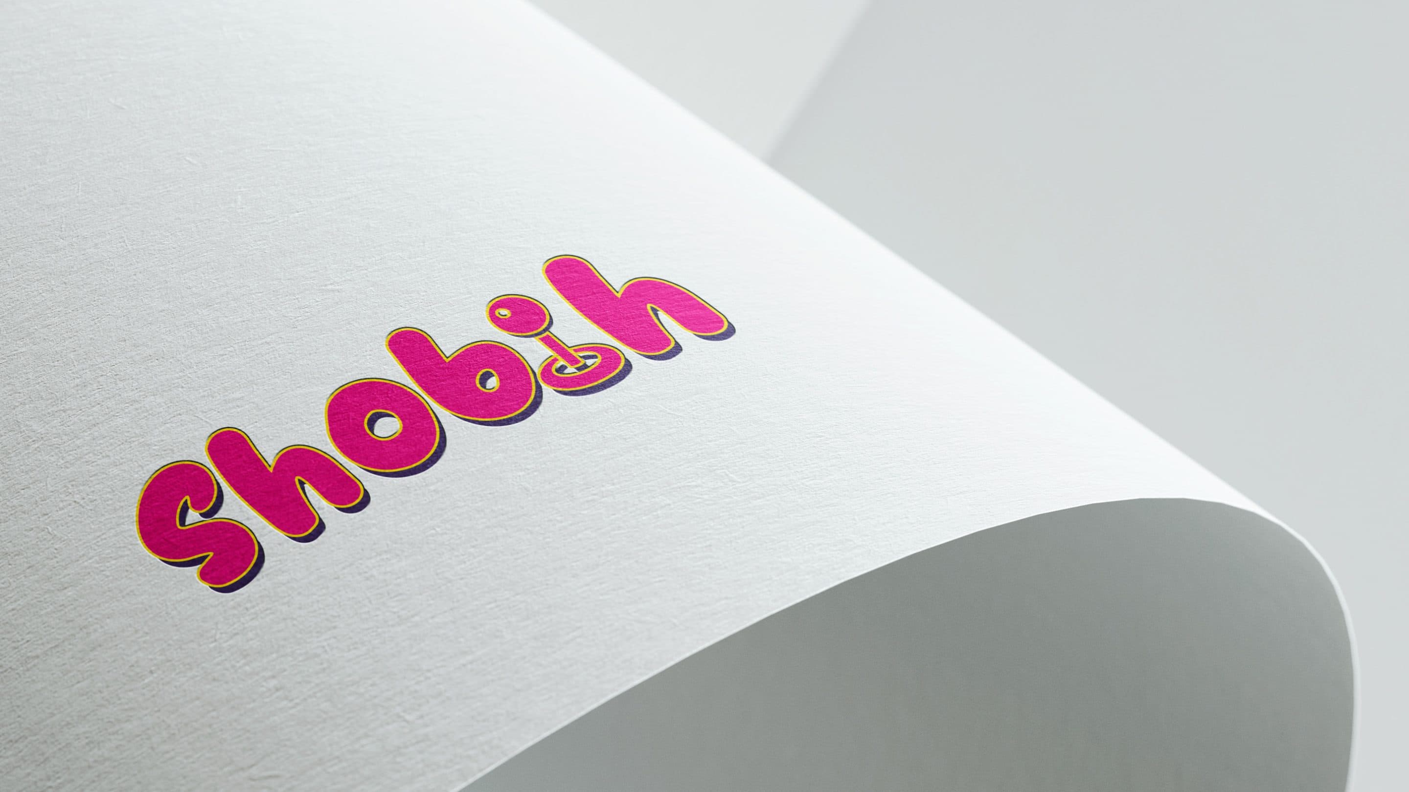 Detail of the logotype embossed in pink on curved paper